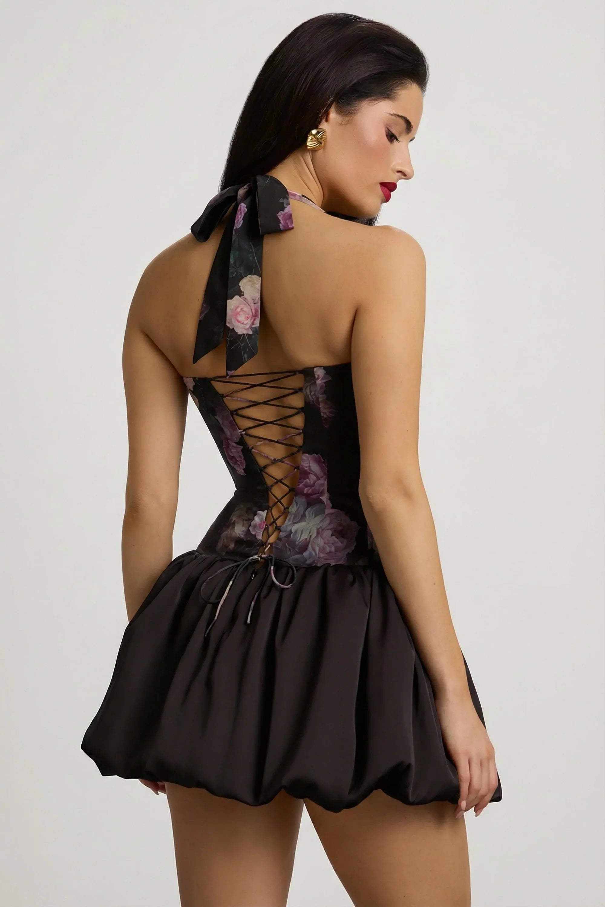 Halterneck Lace Up Bubble Hem Mini Dress in Black Floral Print